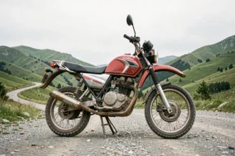 Honda XL 500 garée sur une route de montagne sinueuse, vue grand angle mettant en valeur le cadre robuste et les pneus tout-terrain